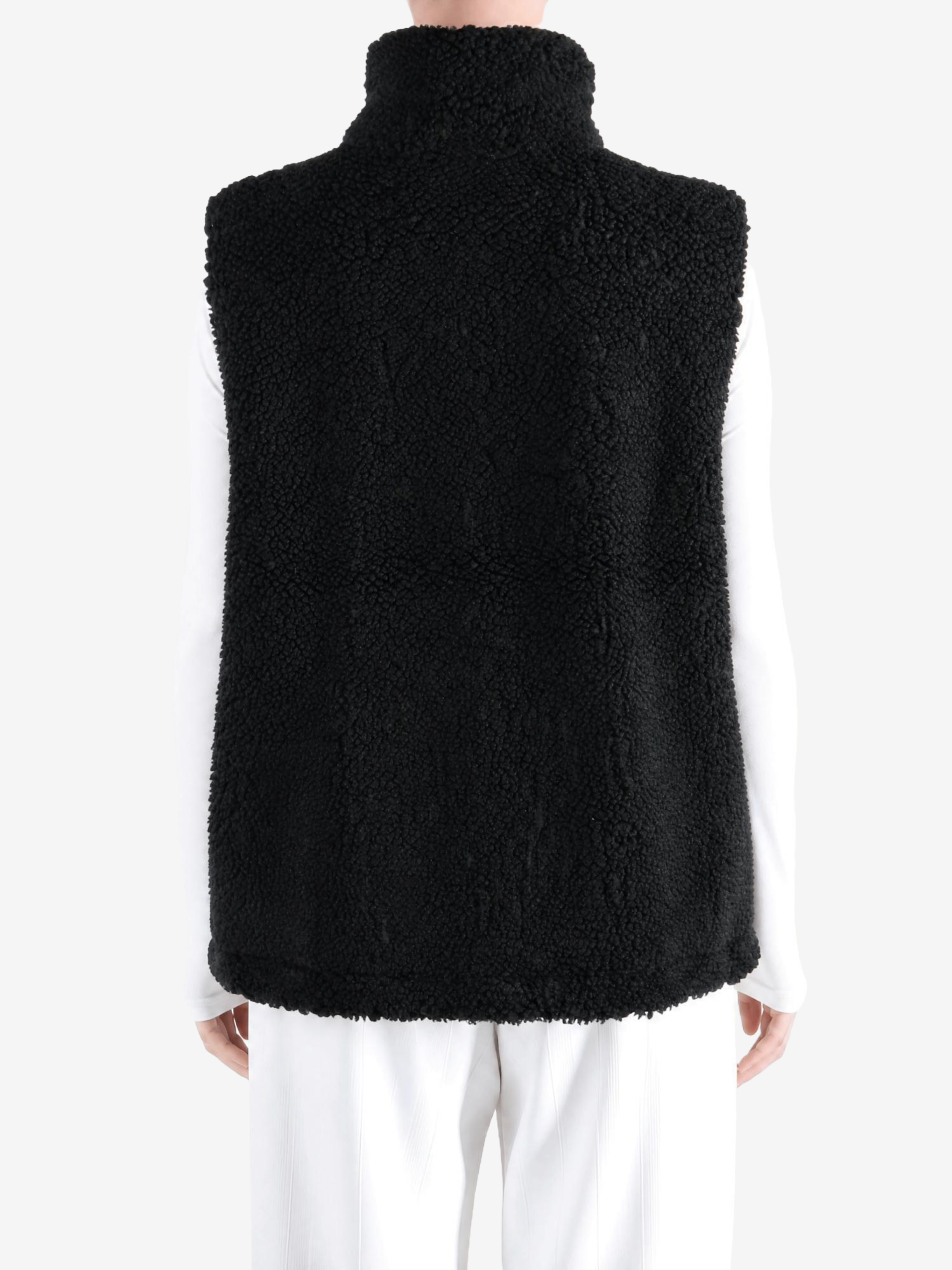Black top worn by a person, showing the top fit