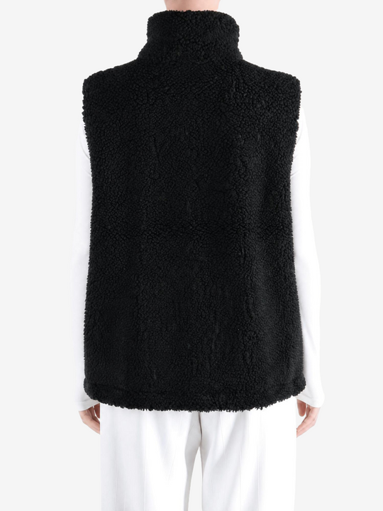 Black top worn by a person, showing the top fit