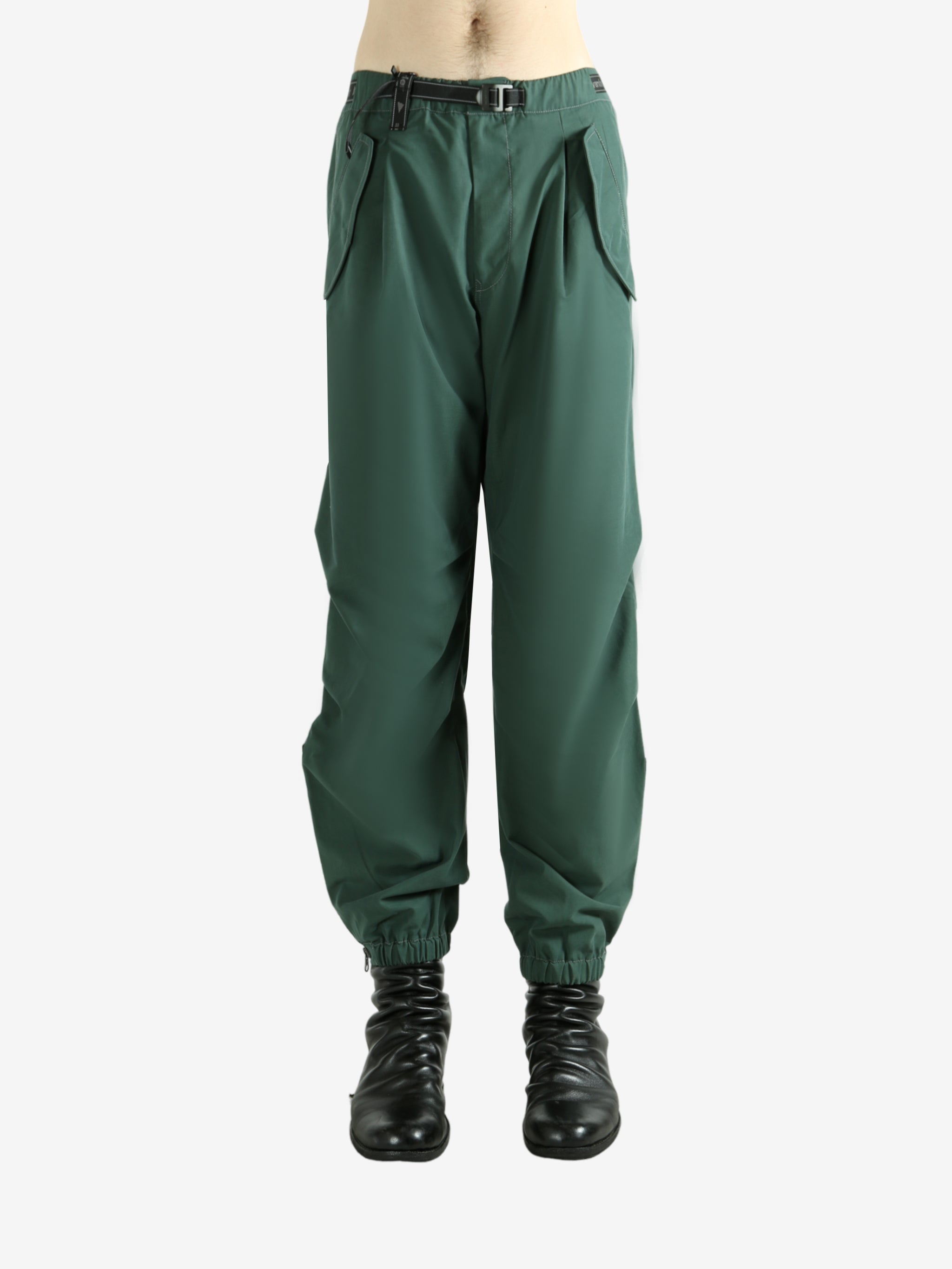 Green pants worn by a person, showing the pants's fit