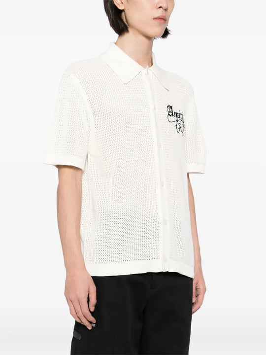 White knitwear worn by a person, showing the knitwear fit