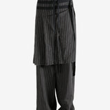 Black pants worn by a person, showing the pants' fit