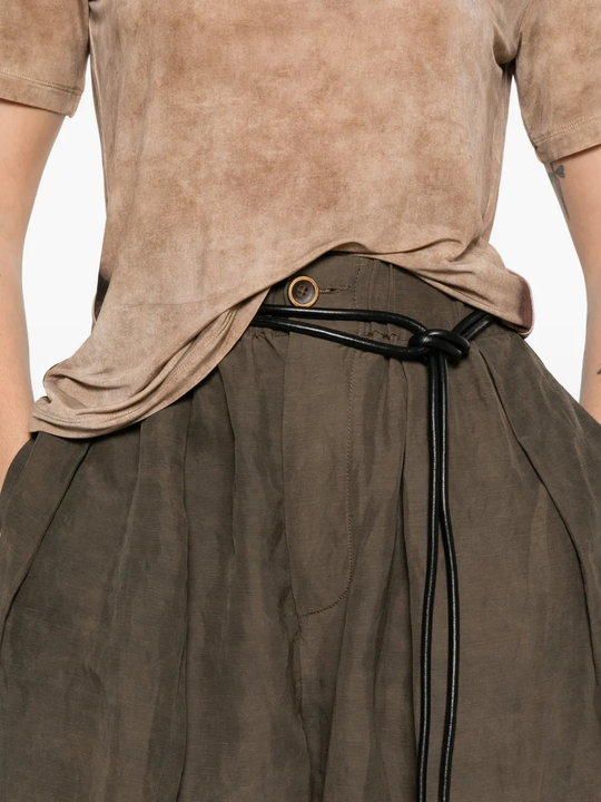 Close up of brown pants, showing texture of the 61% Fiber/ 39% Linen fabric