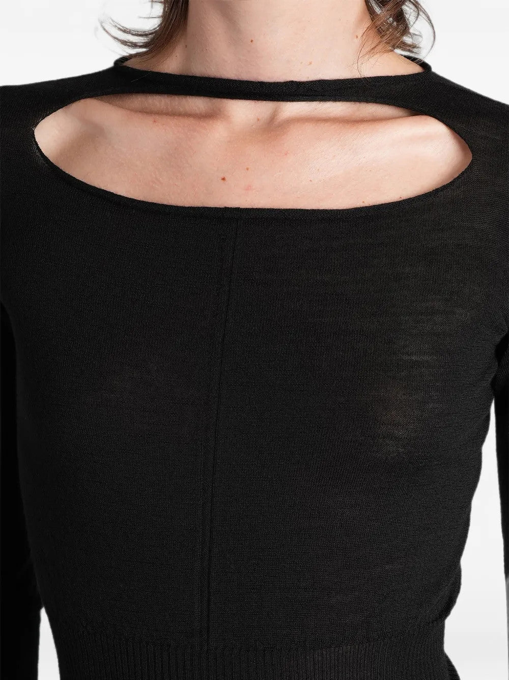 Black top worn by a person, showing the top fit
