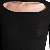 Black top worn by a person, showing the top fit