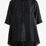 Black shirt worn by a person, showing the shirt's fit