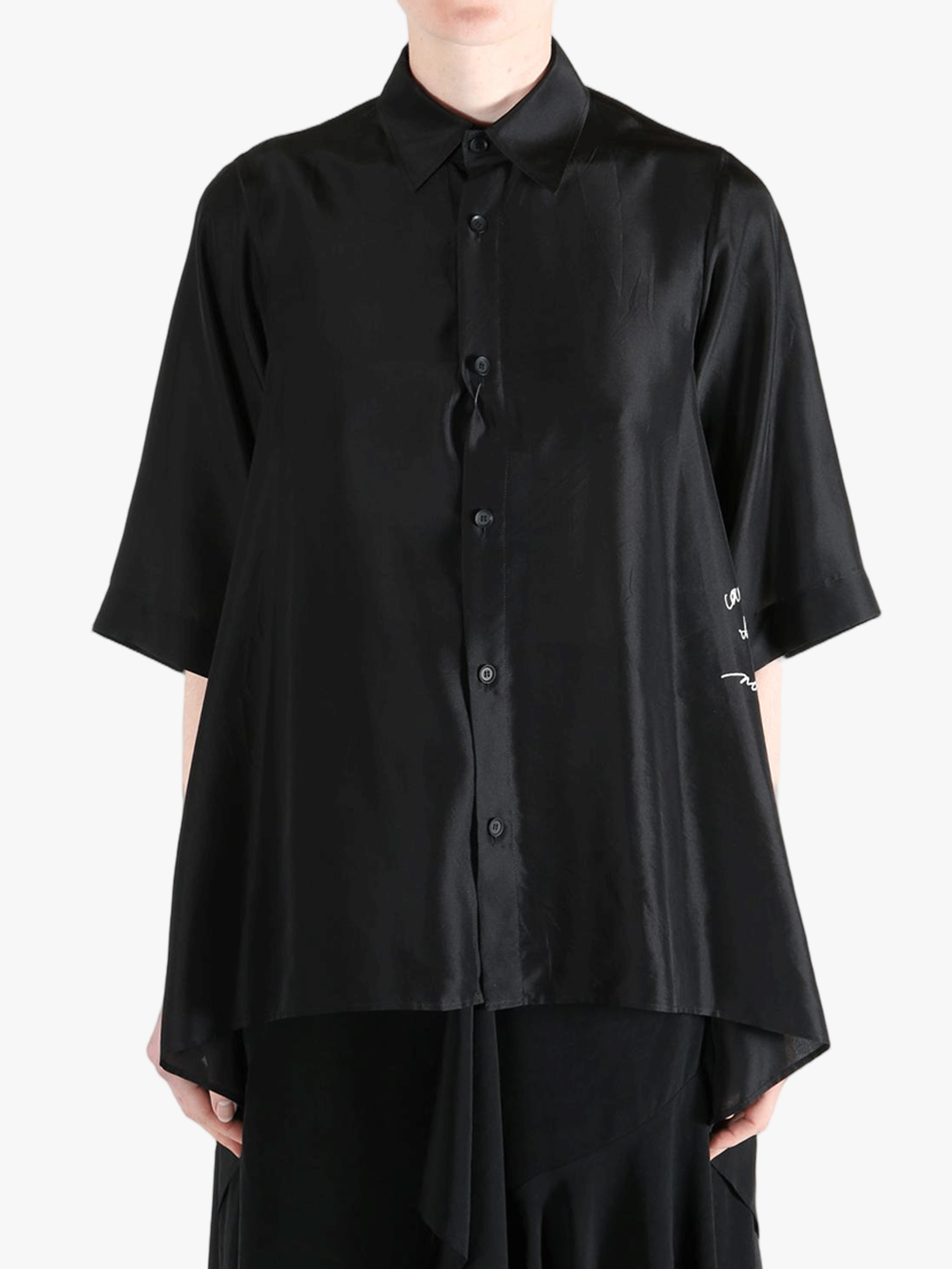 Black shirt worn by a person, showing the shirt's fit