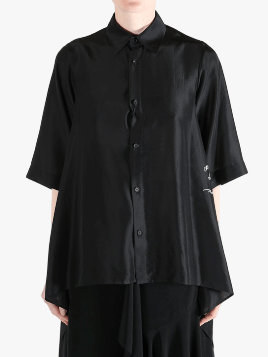 Black shirt worn by a person, showing the shirt's fit