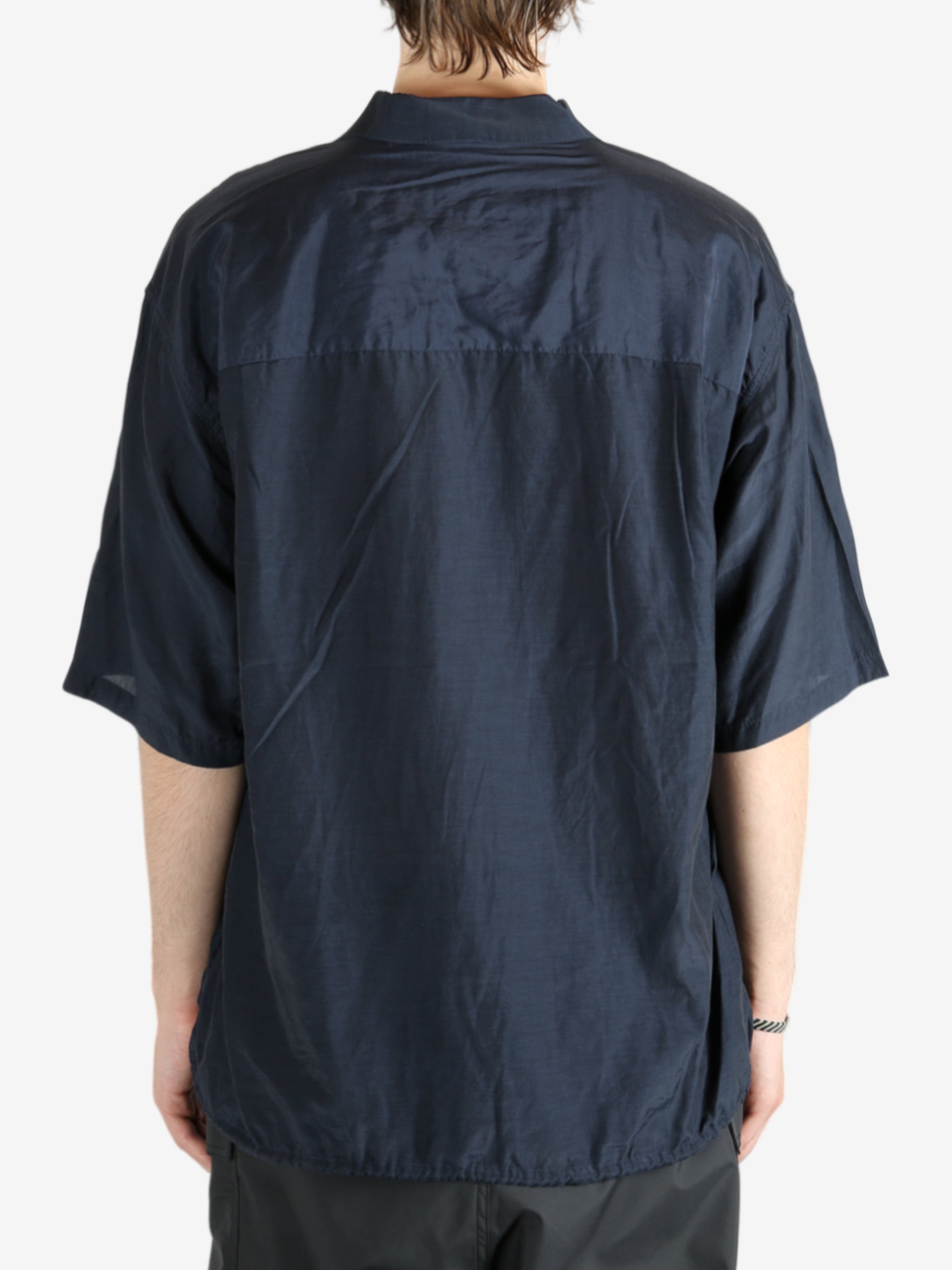 Blue shirt worn by a person, showing the shirt's fit