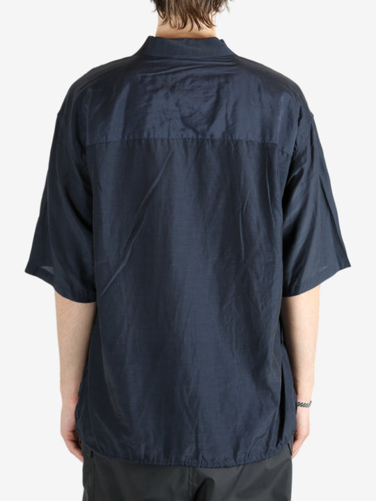 Blue shirt worn by a person, showing the shirt's fit