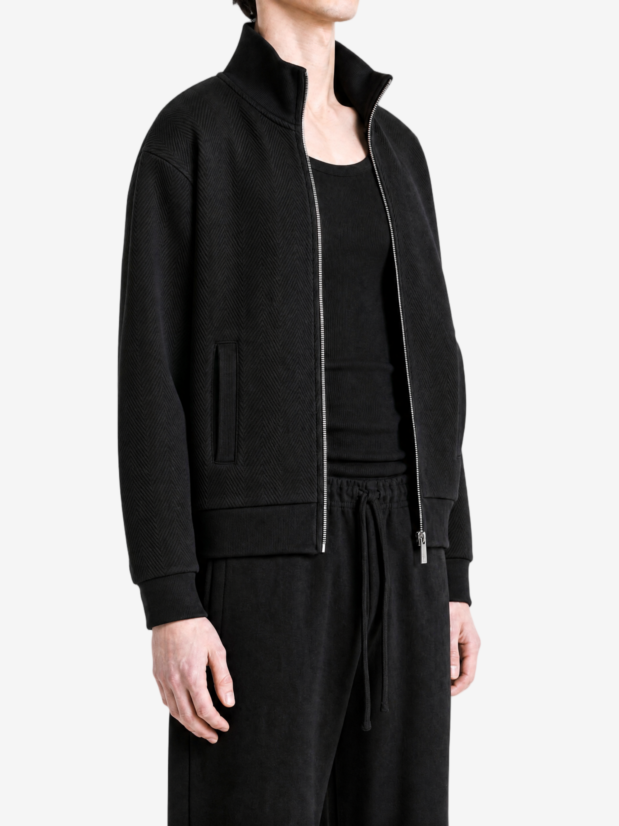 Black hoodie worn by a person, showing the hoodie fit