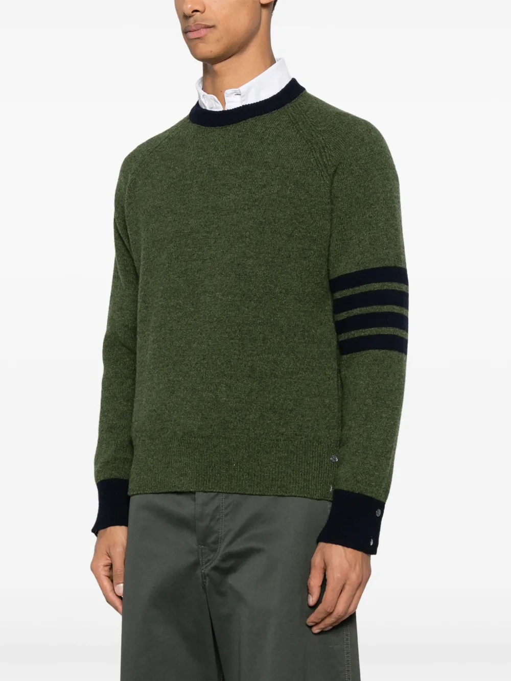 green knitwear worn by a person, showing the knitwear fit