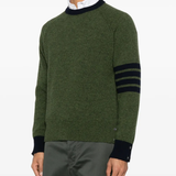 green knitwear worn by a person, showing the knitwear fit