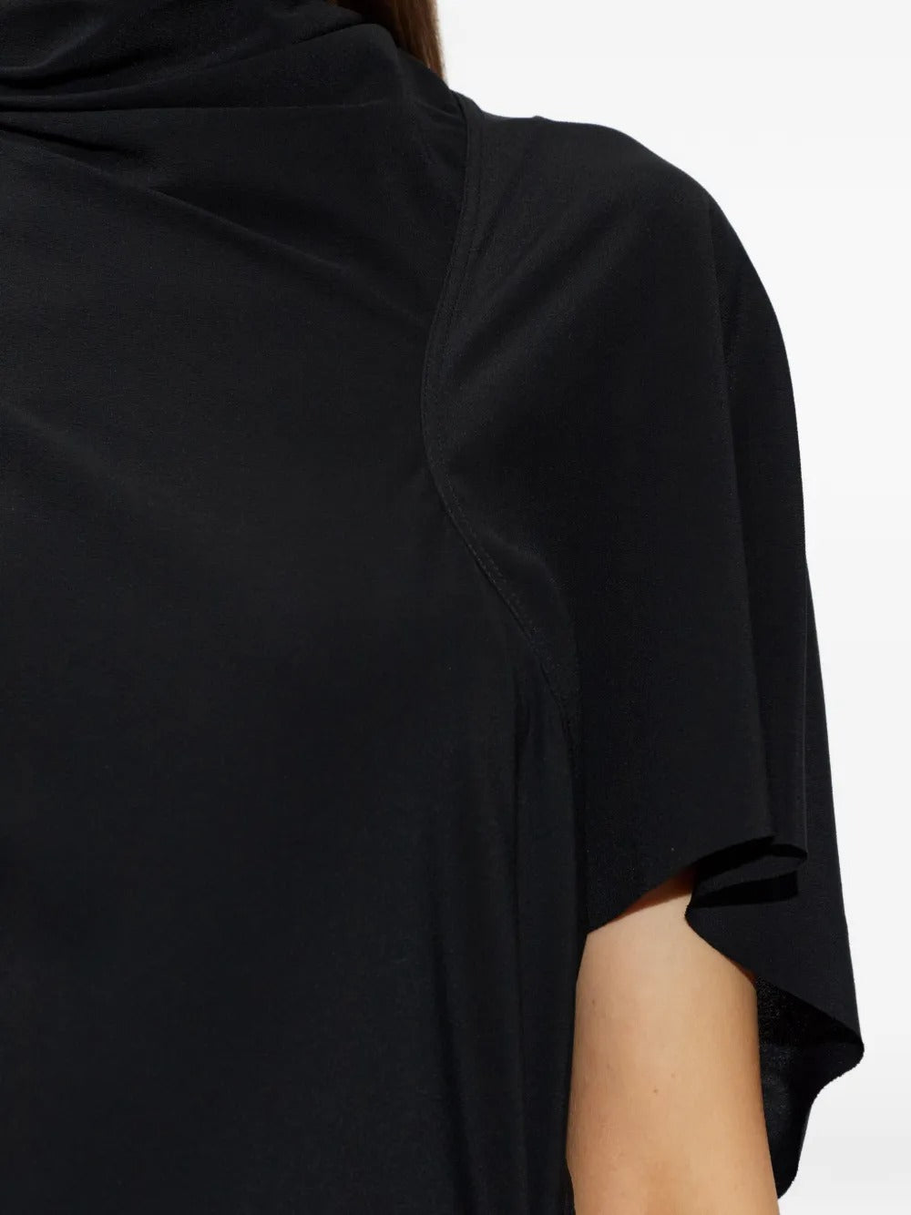 Close up of black dresses, showing texture of the silk and acetate fabric