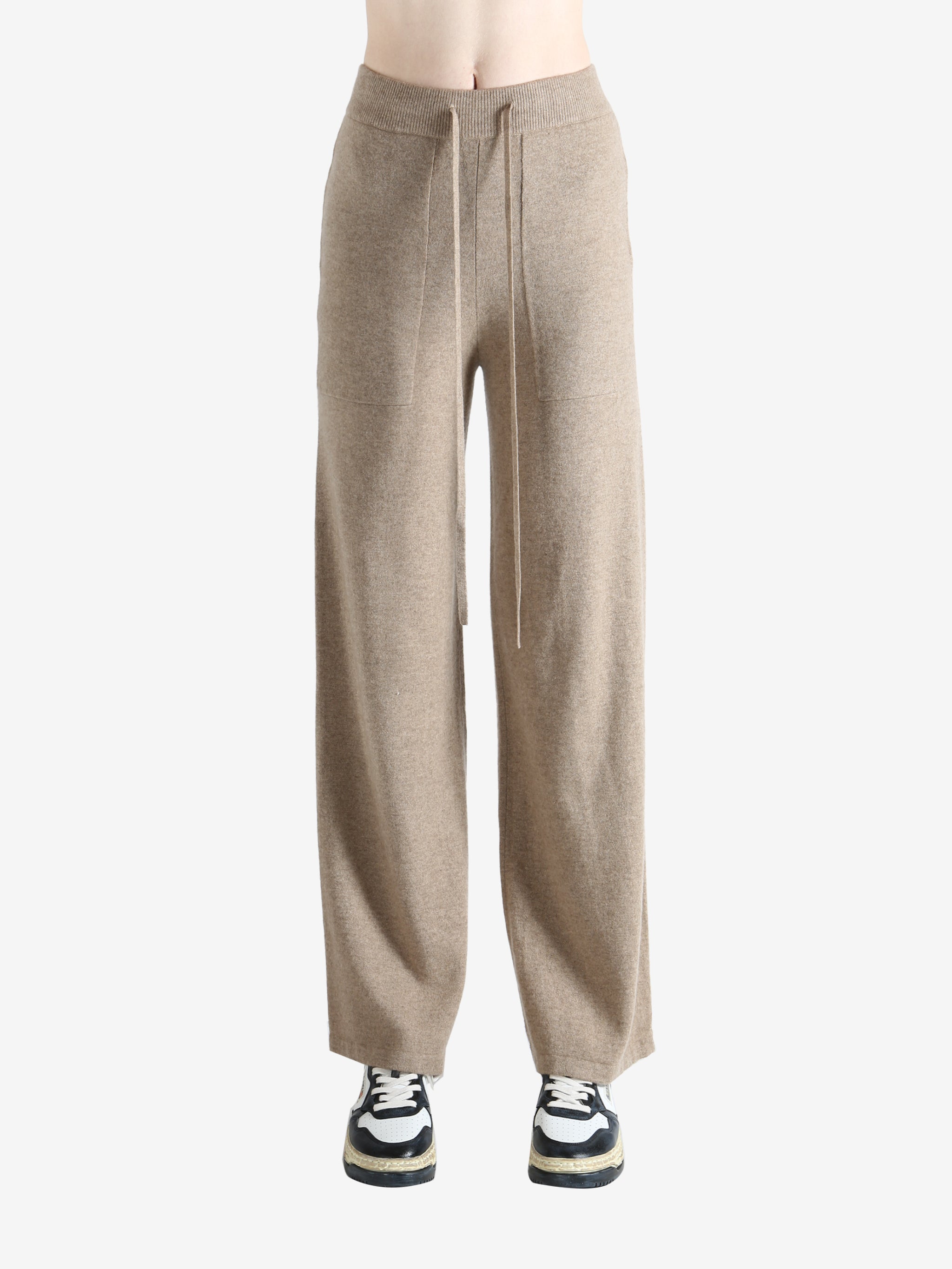 Beige pants worn by a person, showing the pants fit