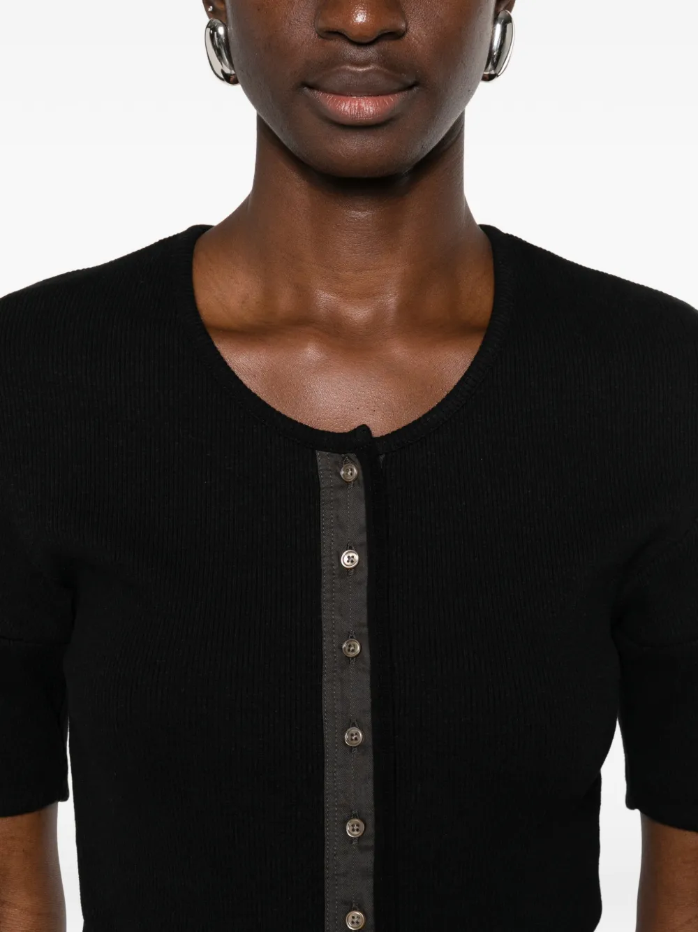 Close up of black shirt, showing texture of the cotton fabric