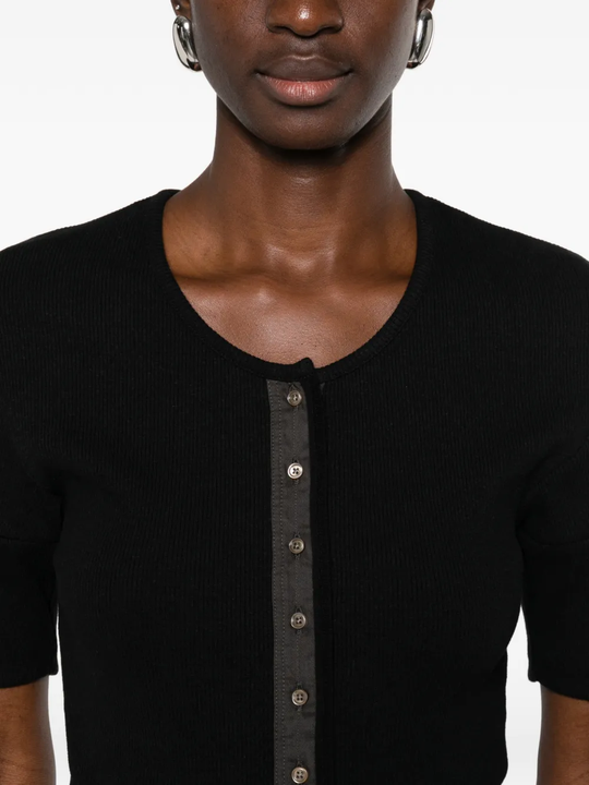 Close up of black shirt, showing texture of the cotton fabric