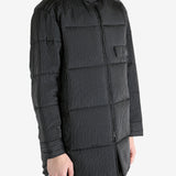 Black coat worn by a person, showing the coat's fit