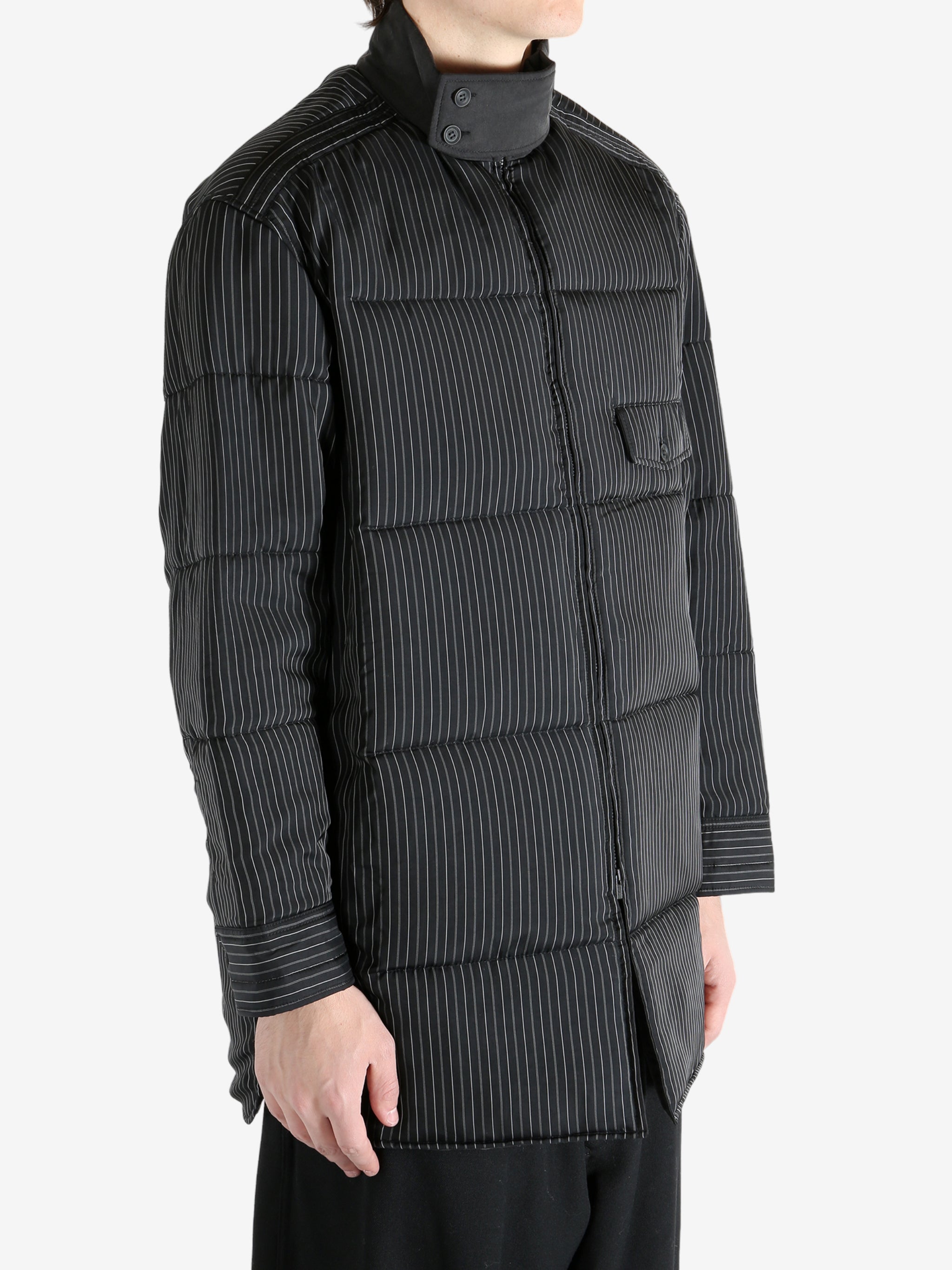 Black coat worn by a person, showing the coat's fit