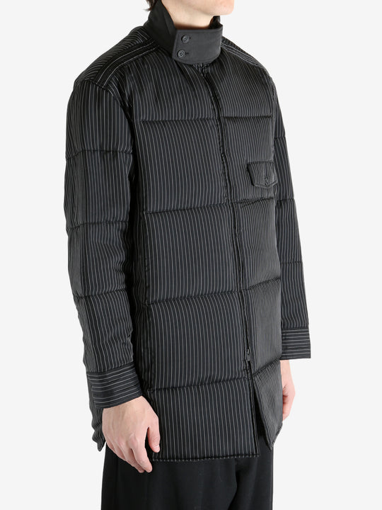 Black coat worn by a person, showing the coat's fit