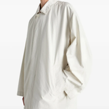 White coat worn by a person, showing the coat fit