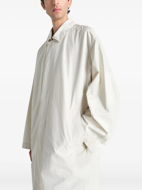 White coat worn by a person, showing the coat fit