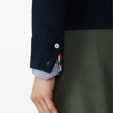 Close up of navy knitwear, showing texture of the Virgin Wool fabric