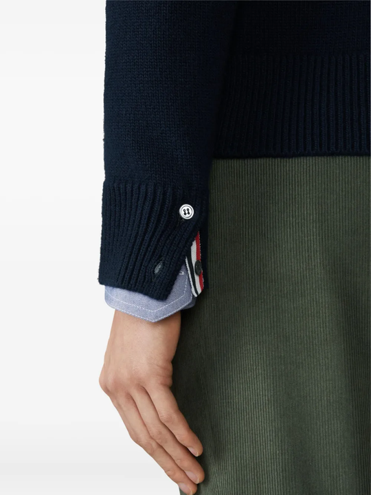 Close up of navy knitwear, showing texture of the Virgin Wool fabric