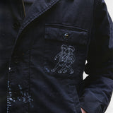 Close up of black jacket, showing texture of the cotton fabric