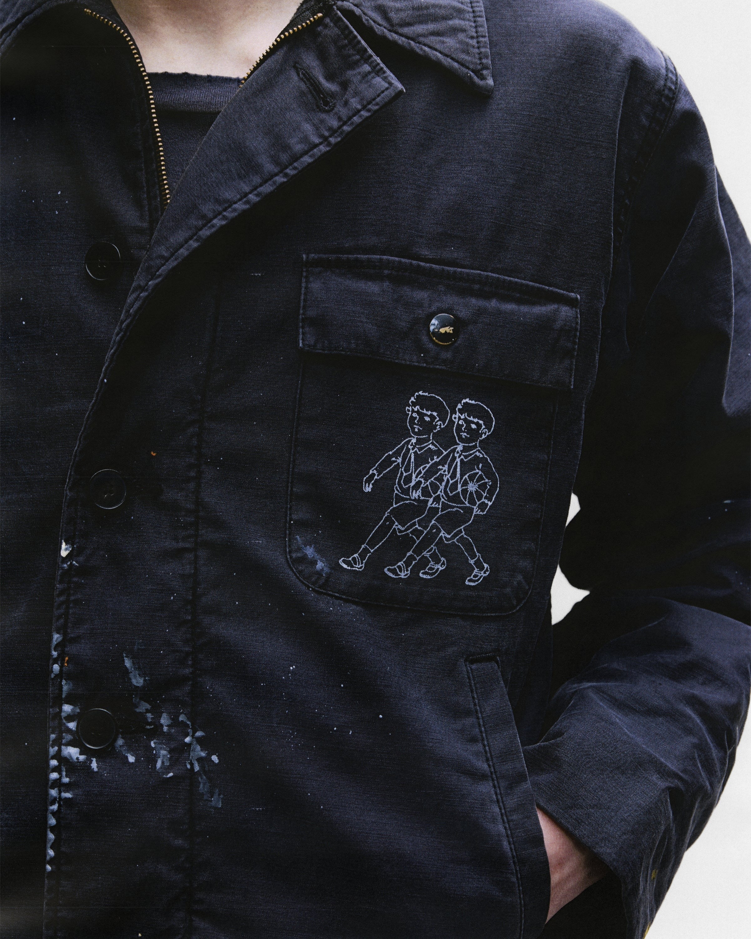 Close up of black jacket, showing texture of the cotton fabric