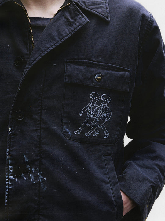 Close up of black jacket, showing texture of the cotton fabric