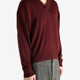 Red sweater worn by a person, showing the sweater's fit