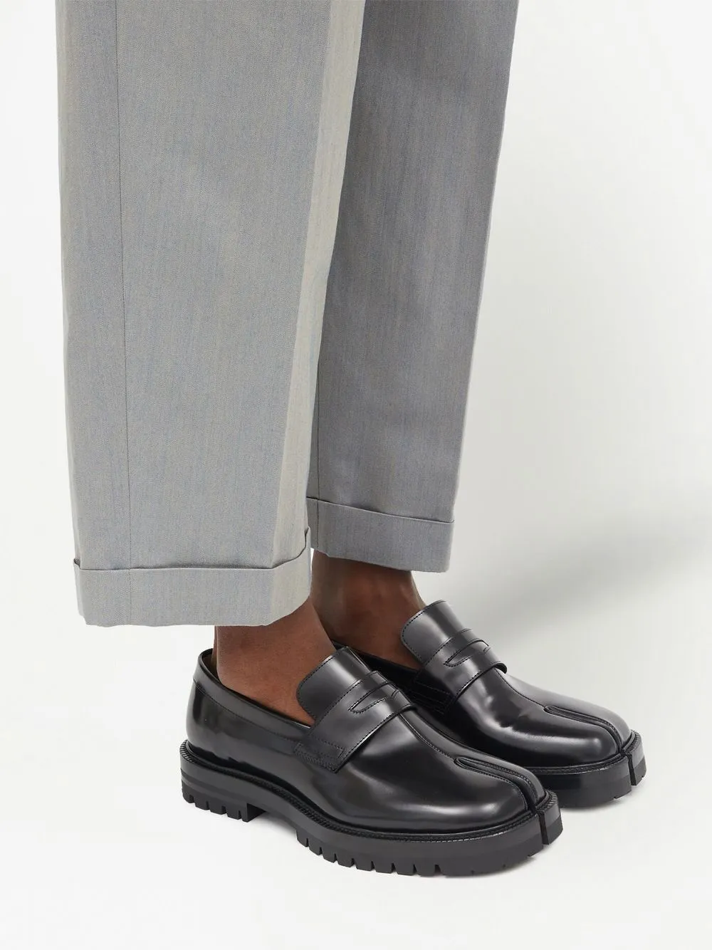 Black loafer worn by a person, showing the loafer's fit