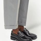 Black loafer worn by a person, showing the loafer's fit