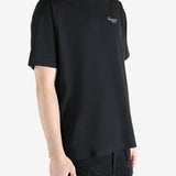 Black t-shirt worn by a person, showing the shirt's fit