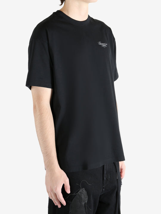 Black t-shirt worn by a person, showing the shirt's fit