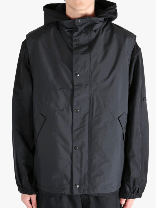 Black top worn by a person, showing the top's fit