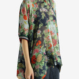 Green top worn by a person, showing the top fit