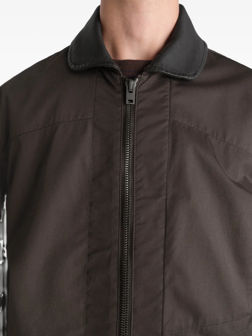 Brown jacket worn by a person, showing the jacket fit