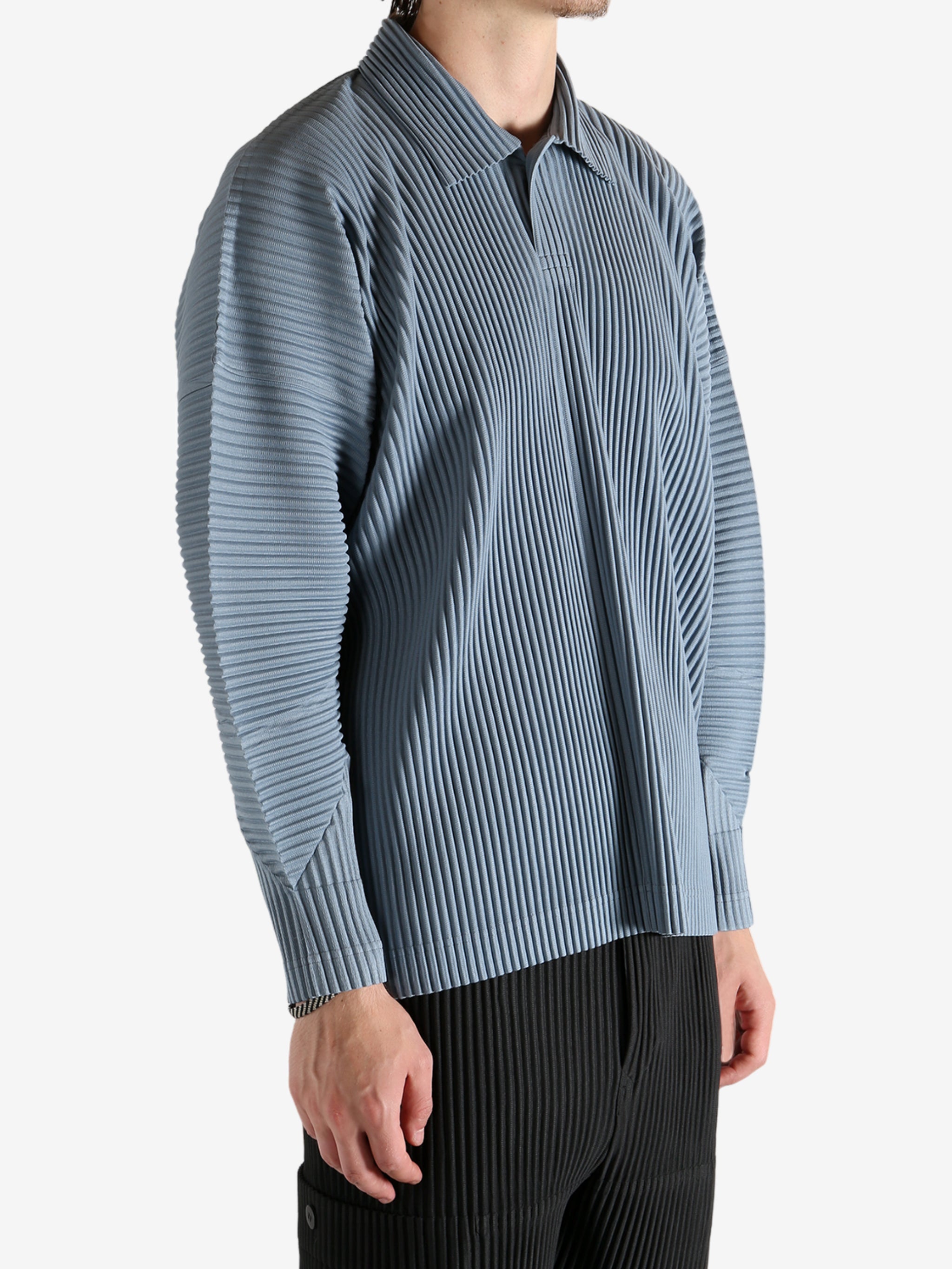 Blue shirts worn by a person, showing the shirt's fit