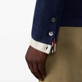 Navy knitwear worn by a person, showing the knitwear fit