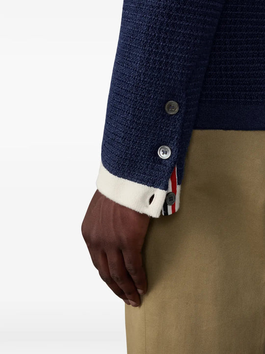 Navy knitwear worn by a person, showing the knitwear fit