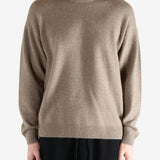 Brown knitwear worn by a person, showing the knitwear's fit