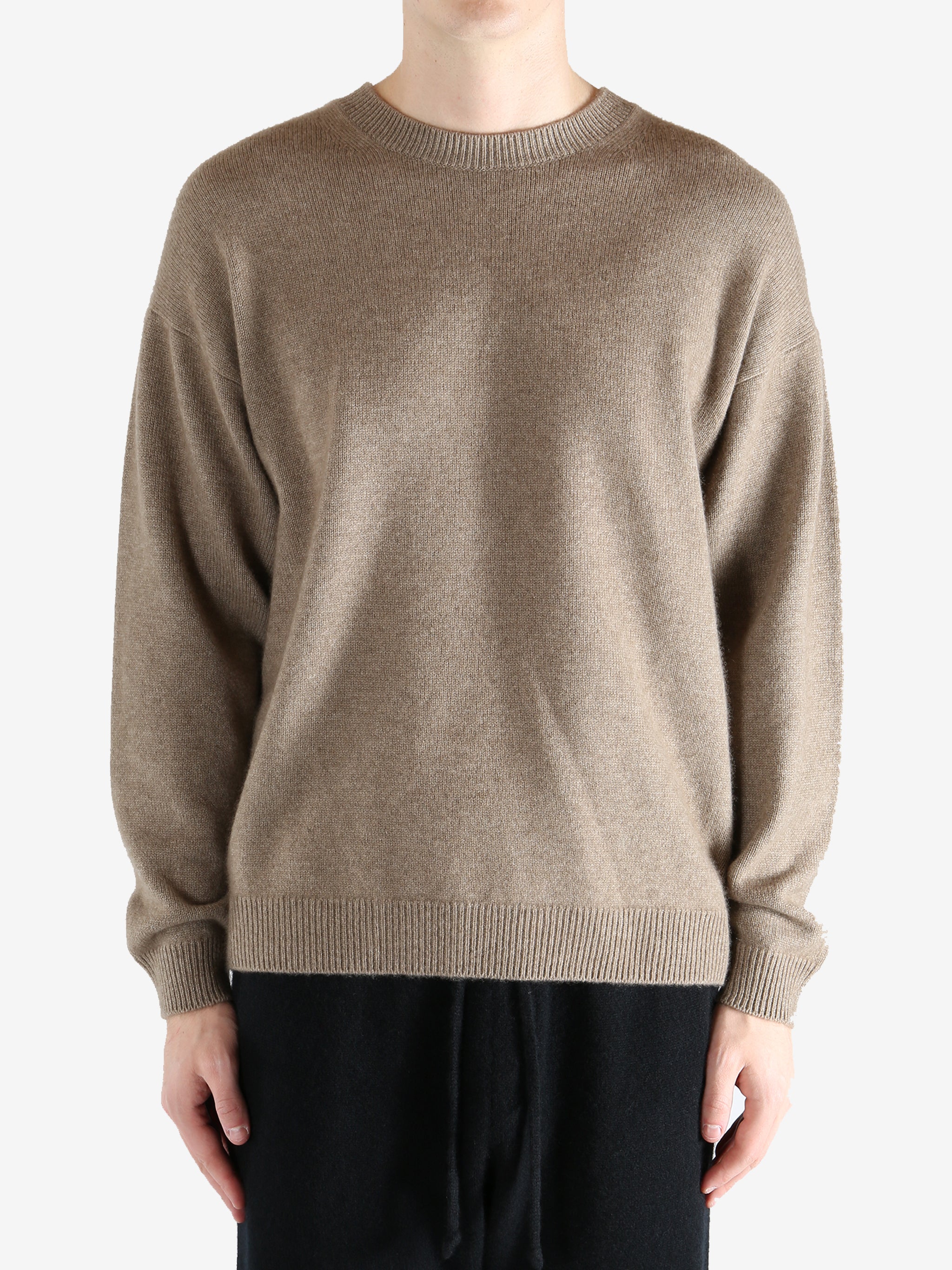 Brown knitwear worn by a person, showing the knitwear's fit