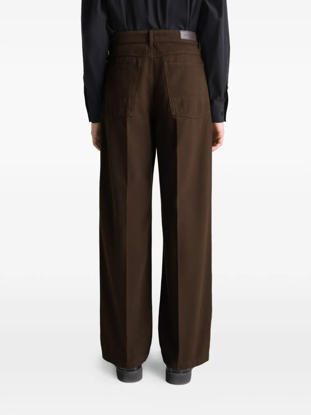 Brown pant worn by a person, showing the pant's fit