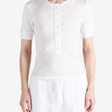 White top worn by a person, showing the top fit