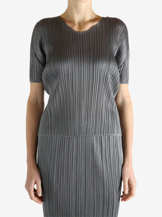 Grey shirts worn by a person, showing the shirts fit