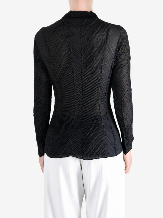 Black shirt worn by a person, showing the shirt fit