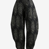 Black pants worn by a person, showing the pants's fit