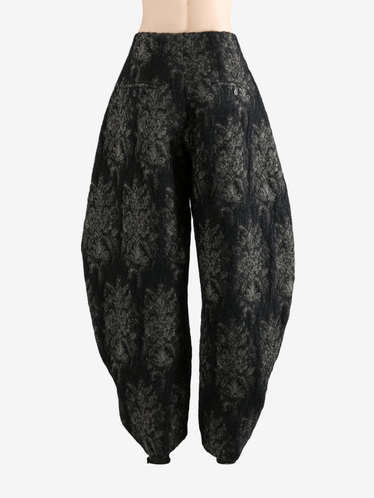 Black pants worn by a person, showing the pants's fit