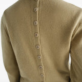 Tan hoodie worn by a person, showing the hoodie fit